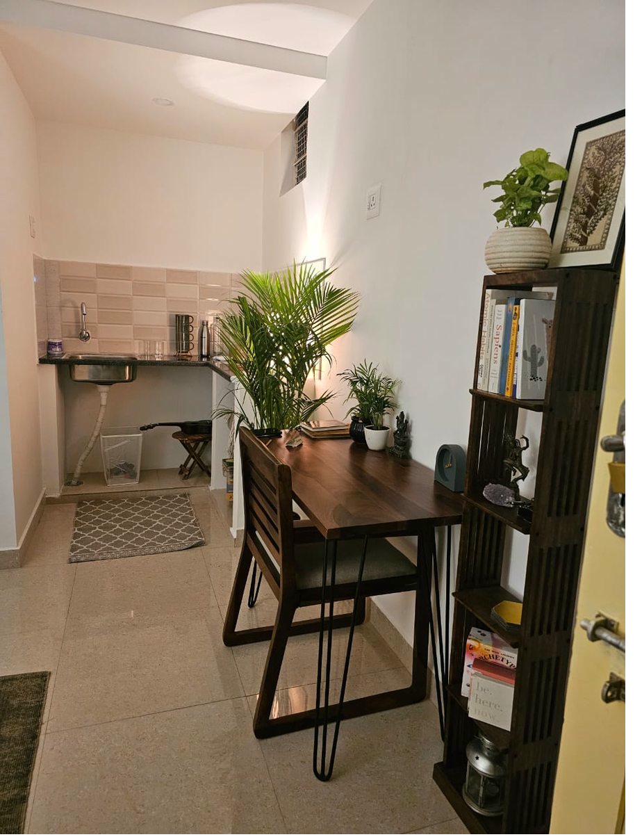 Studio Amhi — desk, bookshelf and kitchen area